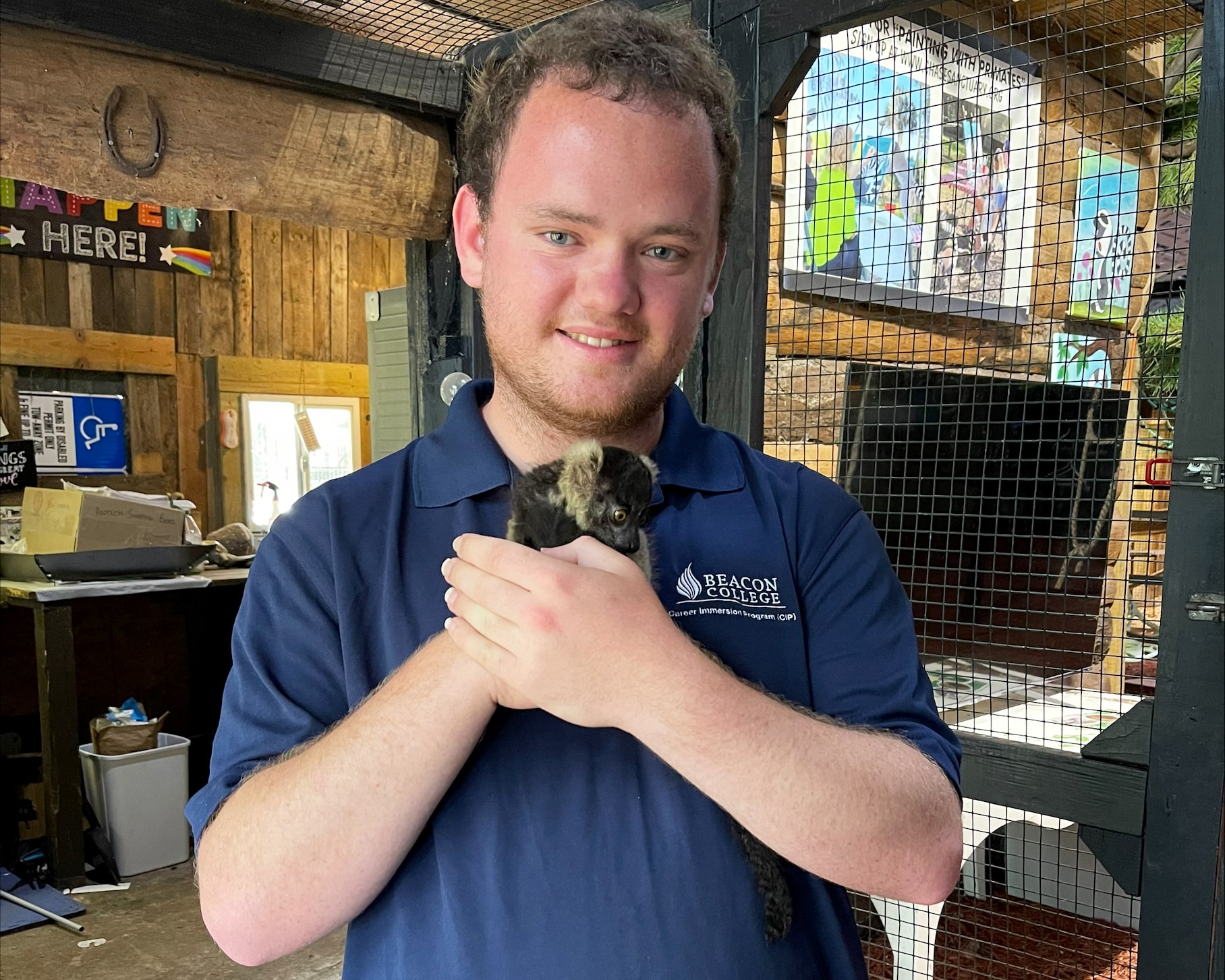 Javier Escudero hangs out with a furry friend during his summer internship through the Beacon Career Immersion Program.