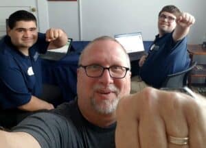 Beacon students Benjamin Strauss (left) and Ben Korb (right, wearing glasses) pose with their supervisor Dan King during their internship with Fist Bump Media.