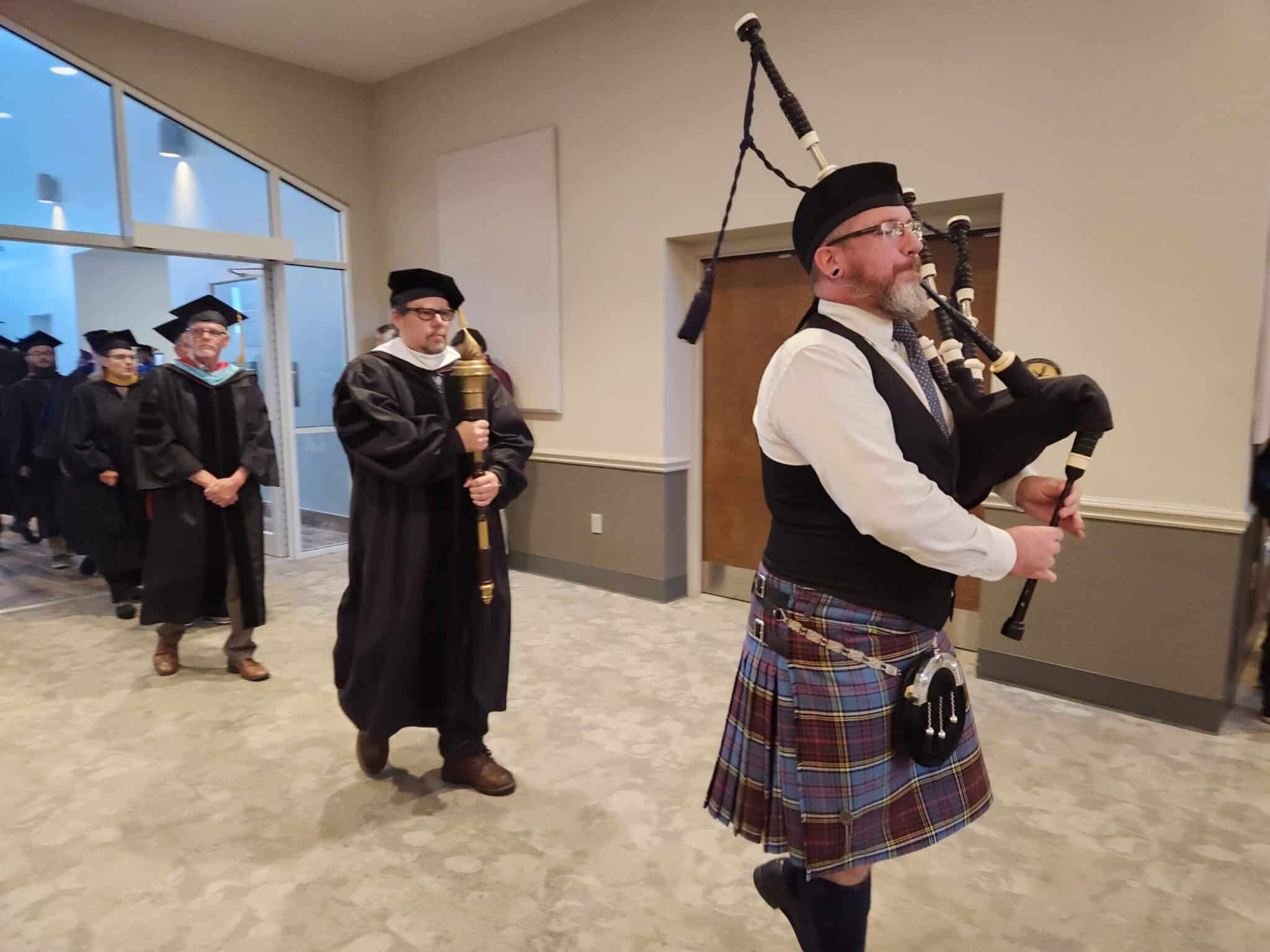 Beacon College Convocation entrance with bagpiper 2023.