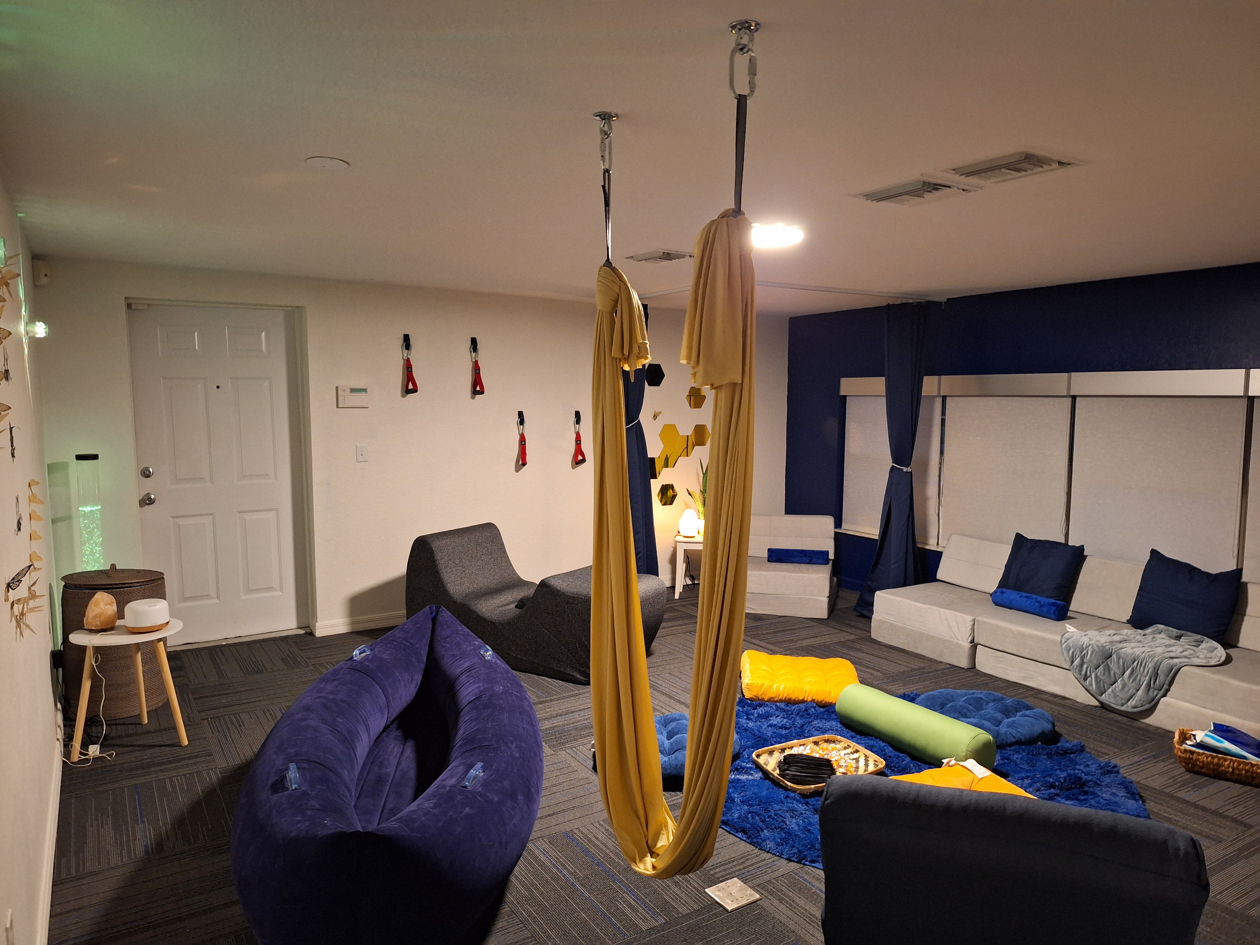 Beacon's new sensory room with cushioned couches, a hammock style chair and more soft surfaces. 